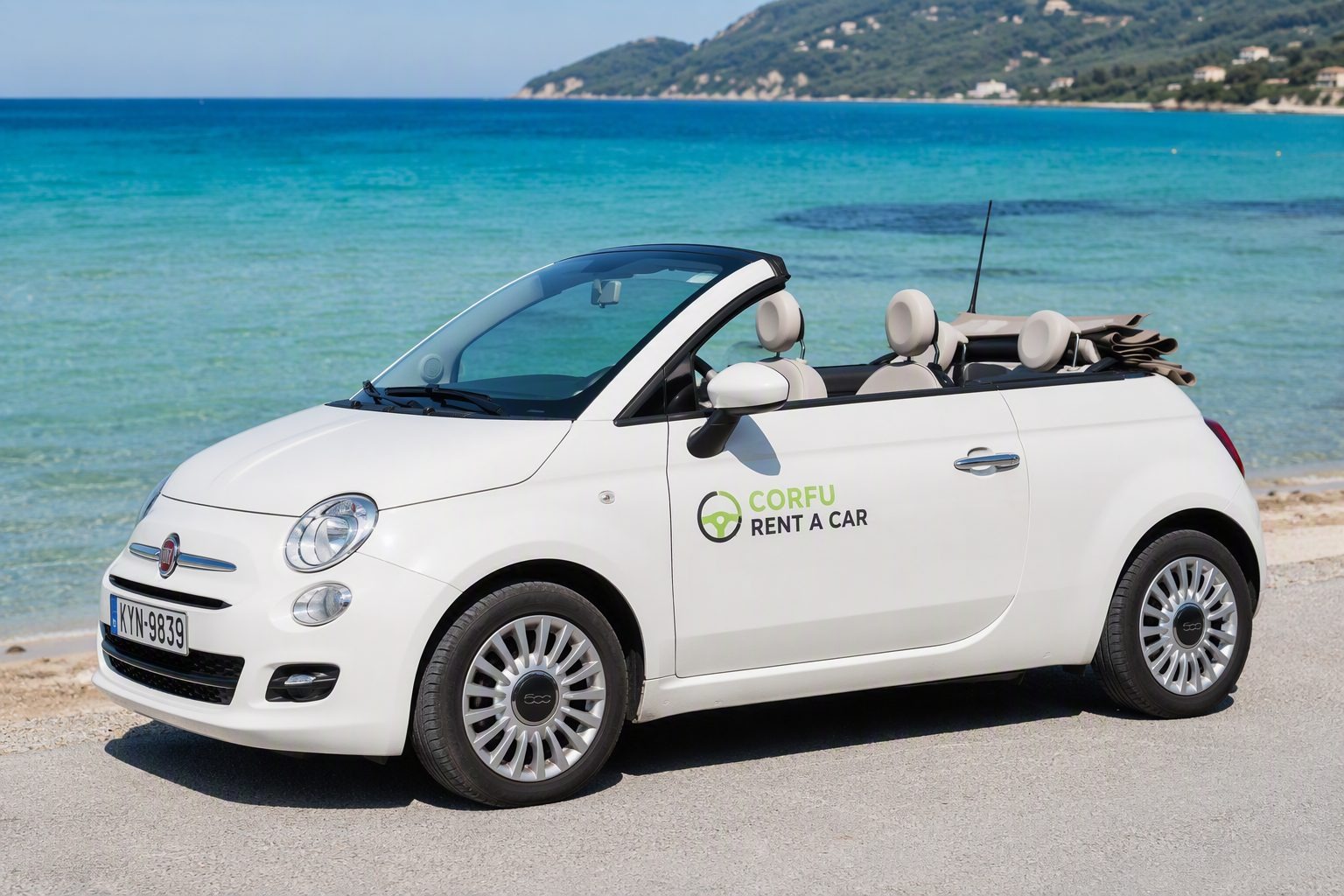 White convertible parked by turquoise water in Corfu