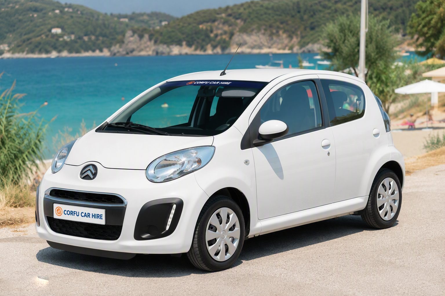 White city car parked by the sea in Agios Georgios Pagi